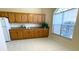 Kitchen with wood cabinets, granite countertops, and a window for natural light at 1726 Augustine Dr, The Villages, FL 32159