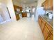 Open kitchen design with tile floors, wooden cabinets, and white appliances at 1726 Augustine Dr, The Villages, FL 32159
