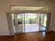 Enclosed lanai with sliding glass doors that offer a view of the golf course at 1726 Augustine Dr, The Villages, FL 32159