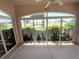 Enclosed lanai showcasing views of the lush landscaping and a golf course at 1726 Augustine Dr, The Villages, FL 32159