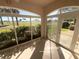Enclosed lanai with a view of the well-manicured golf course and tropical foliage at 1726 Augustine Dr, The Villages, FL 32159