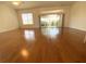 Spacious living room featuring hardwood flooring and sliding glass doors to outdoor area at 1726 Augustine Dr, The Villages, FL 32159