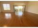 Living room featuring hardwood floors and sliding glass doors with backyard view at 1726 Augustine Dr, The Villages, FL 32159
