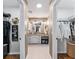 Bright bathroom featuring a granite-topped vanity, white cabinetry, and convenient closet space at 17660 Se 81St Timberwood Ter, The Villages, FL 32162