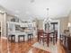 Dining area showcasing hardwood floors, recessed lighting, and a dining table set for four at 17660 Se 81St Timberwood Ter, The Villages, FL 32162