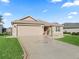 Beautiful one-story home featuring an attached garage, a decorative driveway, and a well-maintained lawn at 17660 Se 81St Timberwood Ter, The Villages, FL 32162