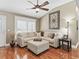 Cozy living room featuring hardwood floors, comfortable seating, and ample natural light at 17660 Se 81St Timberwood Ter, The Villages, FL 32162