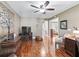 Comfortable living room featuring wood floors, ceiling fan, and ample space for furniture at 17660 Se 81St Timberwood Ter, The Villages, FL 32162