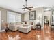 Inviting living room boasting hardwood floors, a large sectional sofa, and stylish decor at 17660 Se 81St Timberwood Ter, The Villages, FL 32162