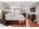 Spacious main bedroom featuring a ceiling fan, a big window, and hardwood floors at 17660 Se 81St Timberwood Ter, The Villages, FL 32162