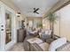 Relaxing sunroom with a ceiling fan, wicker furniture and nice lighting at 17660 Se 81St Timberwood Ter, The Villages, FL 32162