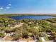 The aerial view showcases the community's lush landscaping and proximity to a serene lake, creating a tranquil environment at 18319 Dells Cove Rd, Groveland, FL 34736