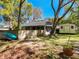 Backyard featuring the screened-in patio, a shed, a kayak, and a fenced-in area, creating a private retreat at 18319 Dells Cove Rd, Groveland, FL 34736