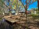 A backyard view displaying the waterfront access, deck, shed, and landscaped stairs to the home at 18319 Dells Cove Rd, Groveland, FL 34736