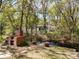 Backyard featuring mature trees, canal, outdoor oven and cooking area with lush greenery at 18319 Dells Cove Rd, Groveland, FL 34736