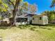 Backyard featuring the screened-in patio of the home and a shed, perfect for outdoor gatherings at 18319 Dells Cove Rd, Groveland, FL 34736