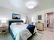 Bedroom featuring a walk-in closet, neutral decor, and artwork on the walls at 18319 Dells Cove Rd, Groveland, FL 34736