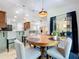 Dining area features a modern round table, chair seating, pendant lighting, and is open to the kitchen at 18319 Dells Cove Rd, Groveland, FL 34736