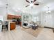 Open-concept living room featuring a breakfast bar, wood floors, and neutral colors at 18319 Dells Cove Rd, Groveland, FL 34736