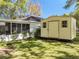 Backyard featuring a shed and the screened-in patio of the home, perfect for outdoor storage at 18319 Dells Cove Rd, Groveland, FL 34736