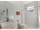 Modern bathroom featuring a vanity, toilet, and a shower with marble and pebble tile, plus natural light at 1851 Soaring Heights Cir, Orlando, FL 32837