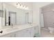 Bathroom featuring dual sinks, a sleek vanity, and a separate shower, showcasing modern design and functionality at 1851 Soaring Heights Cir, Orlando, FL 32837