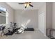 Well-lit room with exercise equipment, featuring neutral walls, a ceiling fan, and a large window for natural light at 1851 Soaring Heights Cir, Orlando, FL 32837