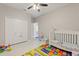 Bright Bedroom with a crib, closet, colorful floor mat, and plenty of room to grow and play at 1851 Soaring Heights Cir, Orlando, FL 32837