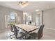 Elegant dining room featuring a modern chandelier, neutral tones, and a large window that fills the space with light at 1851 Soaring Heights Cir, Orlando, FL 32837