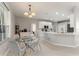 Bright breakfast nook with glass table, leading into kitchen with stainless appliances and island at 1851 Soaring Heights Cir, Orlando, FL 32837