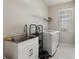 Practical laundry room with white cabinets, a sink, and a washing machine at 1851 Soaring Heights Cir, Orlando, FL 32837