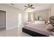 Bright and airy main bedroom with sleek tile flooring and direct access to en-suite bathroom at 1851 Soaring Heights Cir, Orlando, FL 32837