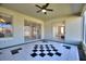 Covered outdoor patio featuring black and white tiled flooring and sliding glass doors to the home's interior at 1851 Soaring Heights Cir, Orlando, FL 32837