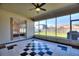 Enclosed patio with tiled floor, a ceiling fan, and sliding glass doors opening to the backyard and adjacent room at 1851 Soaring Heights Cir, Orlando, FL 32837