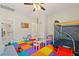 Fun playroom with colorful floor tiles, play structures, and access to a bathroom for convenience at 1851 Soaring Heights Cir, Orlando, FL 32837