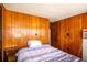 Cozy bedroom featuring wood paneled walls and ample natural light, creating a warm ambiance at 19050 Nfs-573, Altoona, FL 32702