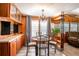 Dining area with vintage chandelier, seating for four, wood paneled walls, and breakfast bar at 19050 Nfs-573, Altoona, FL 32702