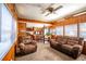 Inviting living room flowing into dining area, featuring comfortable seating and ample natural light at 19050 Nfs-573, Altoona, FL 32702