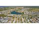 Panoramic aerial view showcasing the community, its winding streets, and a serene lake at 2008 Cipriano Pl, The Villages, FL 32159