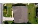 Birds eye view of the property showing the roof, the driveway, and green lawn at 2008 Cipriano Pl, The Villages, FL 32159