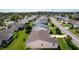 Aerial view showcases the home's location within a serene neighborhood and lush surroundings at 2008 Cipriano Pl, The Villages, FL 32159