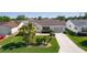 Aerial view of a well-maintained home with a lush lawn and mature landscaping at 2008 Cipriano Pl, The Villages, FL 32159