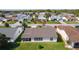 Aerial view of the home's backyard featuring a screened-in porch and well-maintained lawn at 2008 Cipriano Pl, The Villages, FL 32159