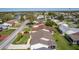 Aerial shot of backyard featuring covered porch, lush lawn, and partial driveway view at 2008 Cipriano Pl, The Villages, FL 32159