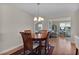 Cozy dining room with a wooden table, chairs, and view to the living room and kitchen at 2008 Cipriano Pl, The Villages, FL 32159