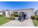 Well-kept home with a golf cart parked in the driveway at 2008 Cipriano Pl, The Villages, FL 32159