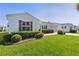 Well-manicured lawn and hedge landscaping highlight this charming home's exterior on a sunny day at 2008 Cipriano Pl, The Villages, FL 32159