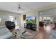 Comfortable living room featuring a TV, open layout, and access to the outdoor patio at 2008 Cipriano Pl, The Villages, FL 32159