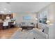 Cozy living room with hardwood floors that opens up to the kitchen at 2008 Cipriano Pl, The Villages, FL 32159