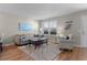 Inviting living room with plantation shutters, neutral walls and hardwood floors at 2008 Cipriano Pl, The Villages, FL 32159